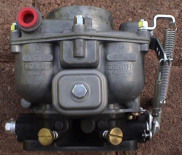 Front view of a restored Zenith 32 NDIX carburetor with throttle linkage and return spring.