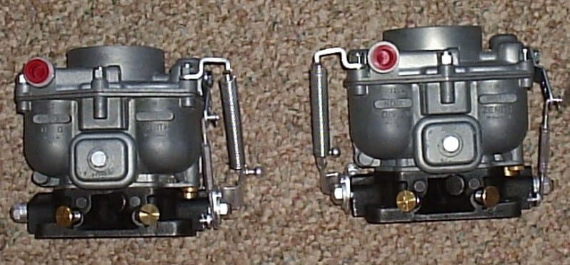A pair of restored Zenith 32 NDIX carburetors shown side by side from the side.
