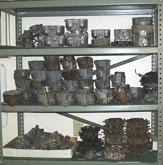 Shelves filled with disassembled Zenith 32 NDIX carburetor cores and bodies awaiting restoration.